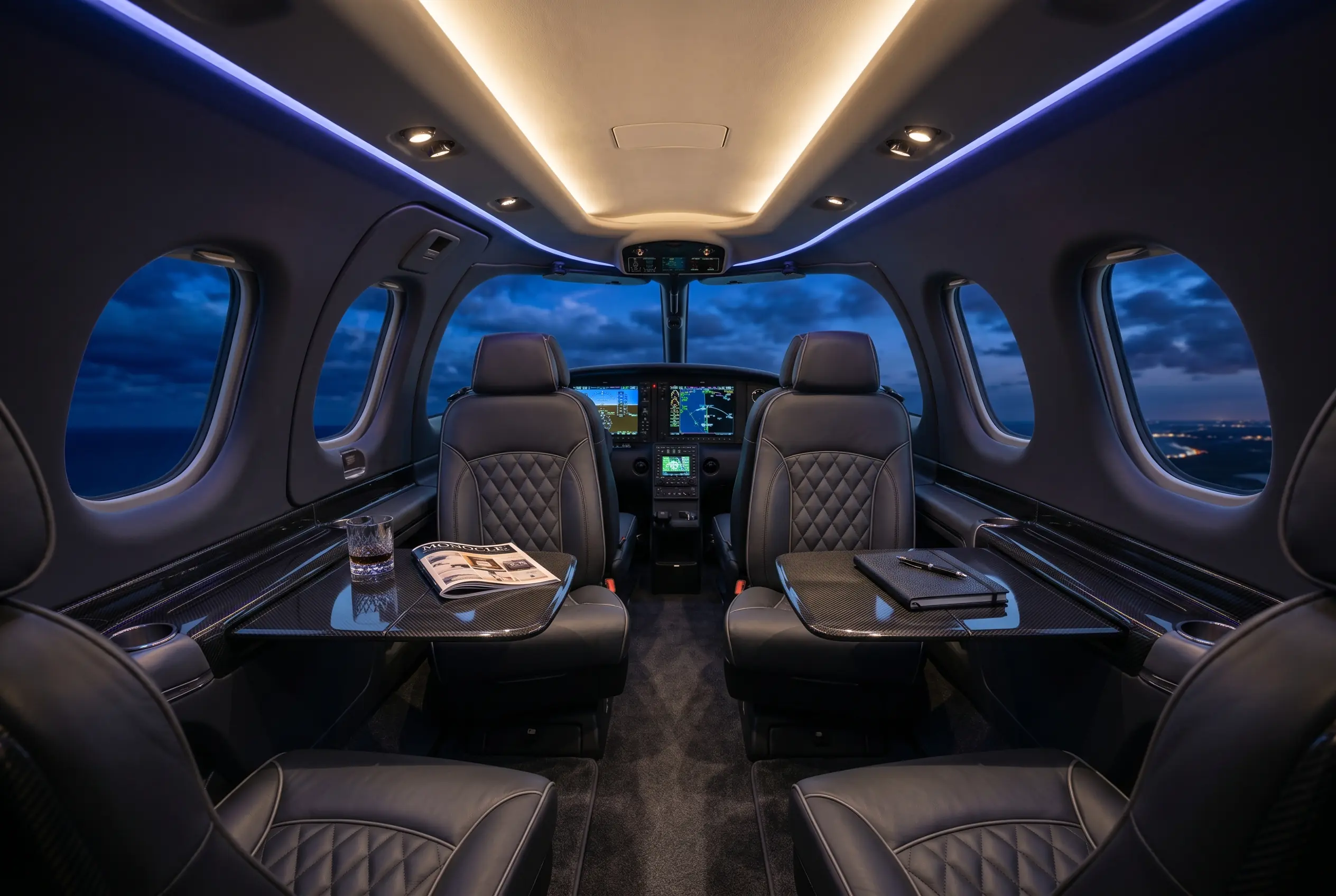 Cirrus Vision Jet G2+ cabin with a panoramic windshield and club seating, configured for a New York to Miami charter
