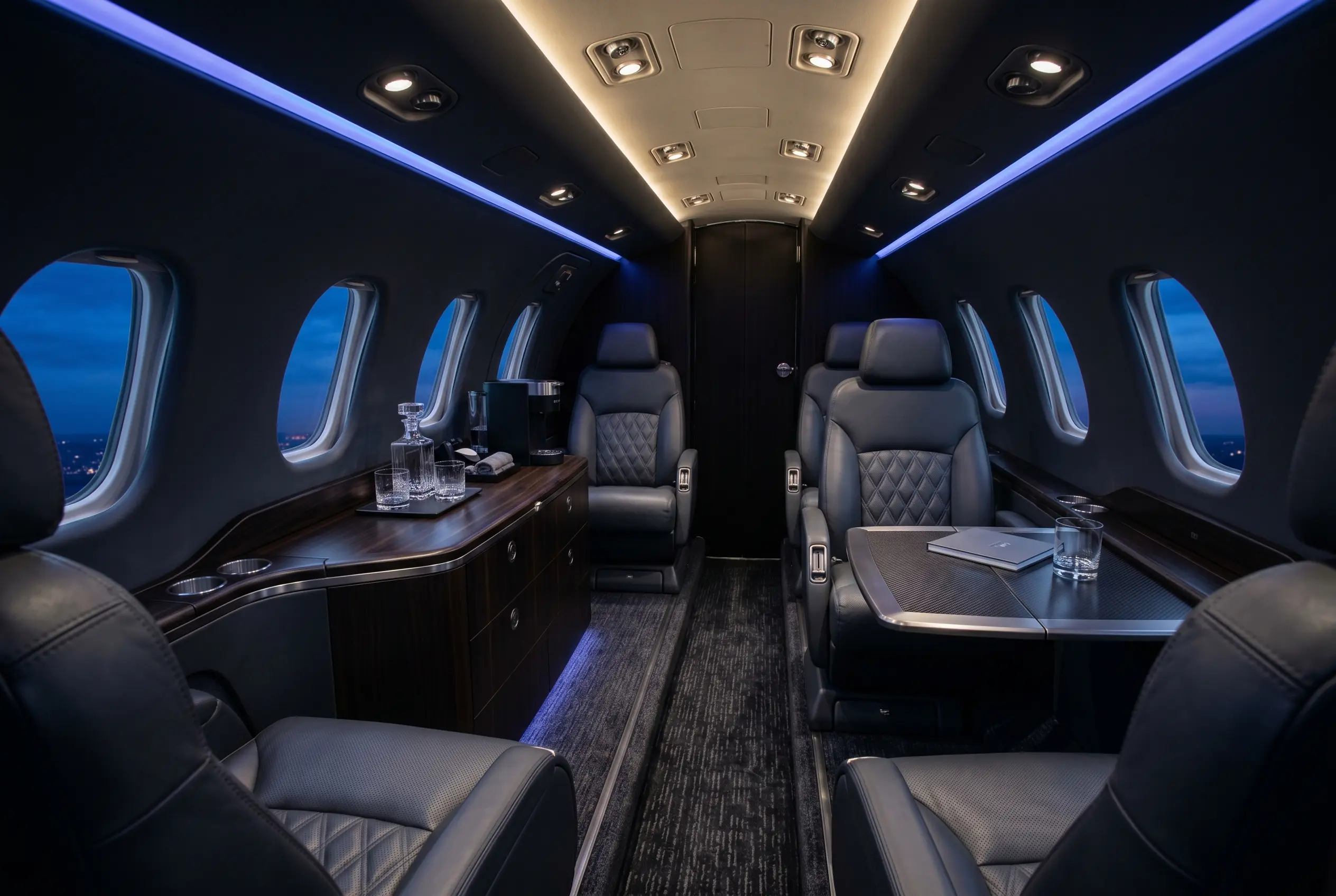 Cessna Citation CJ3+ cabin with club seating and a refreshment console, configured for a New York to Miami charter