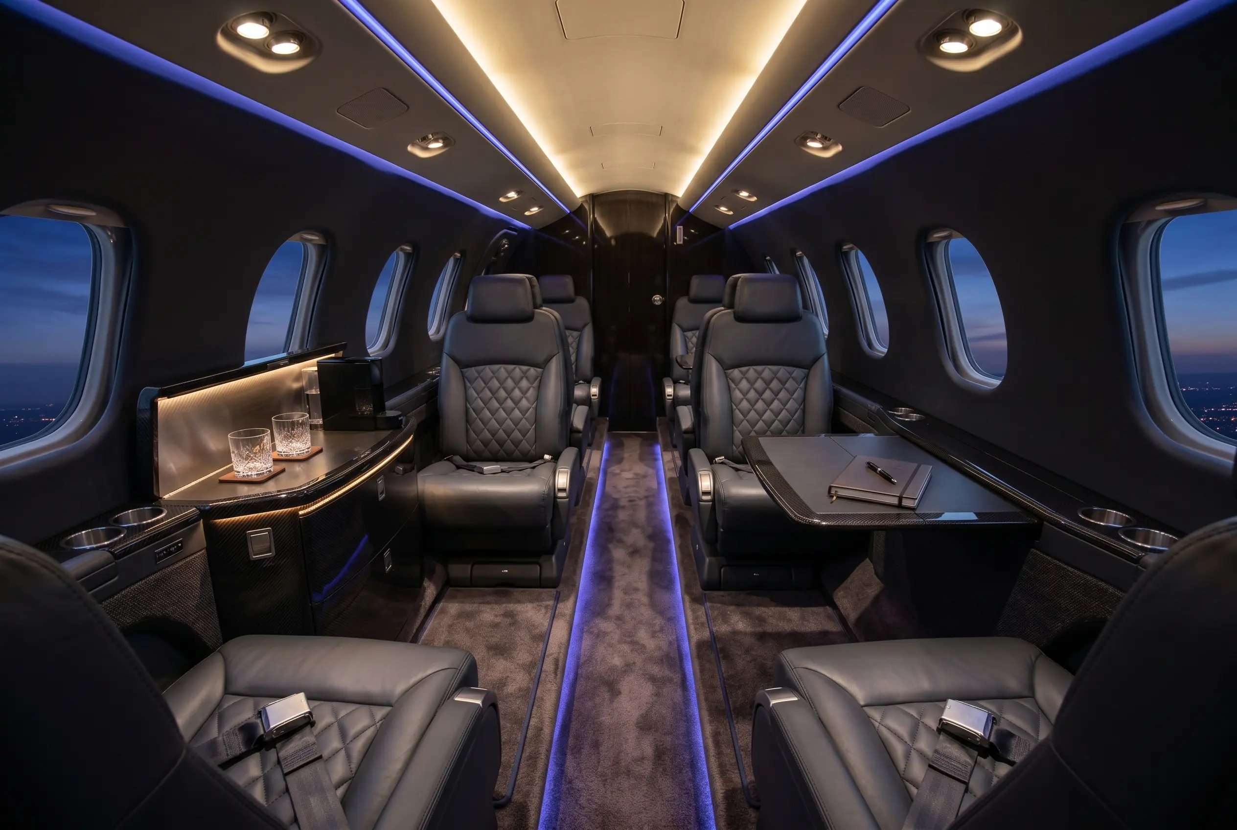 Cessna Citation CJ4 cabin with seven club seats and a refreshment center, configured for a New York to Miami charter