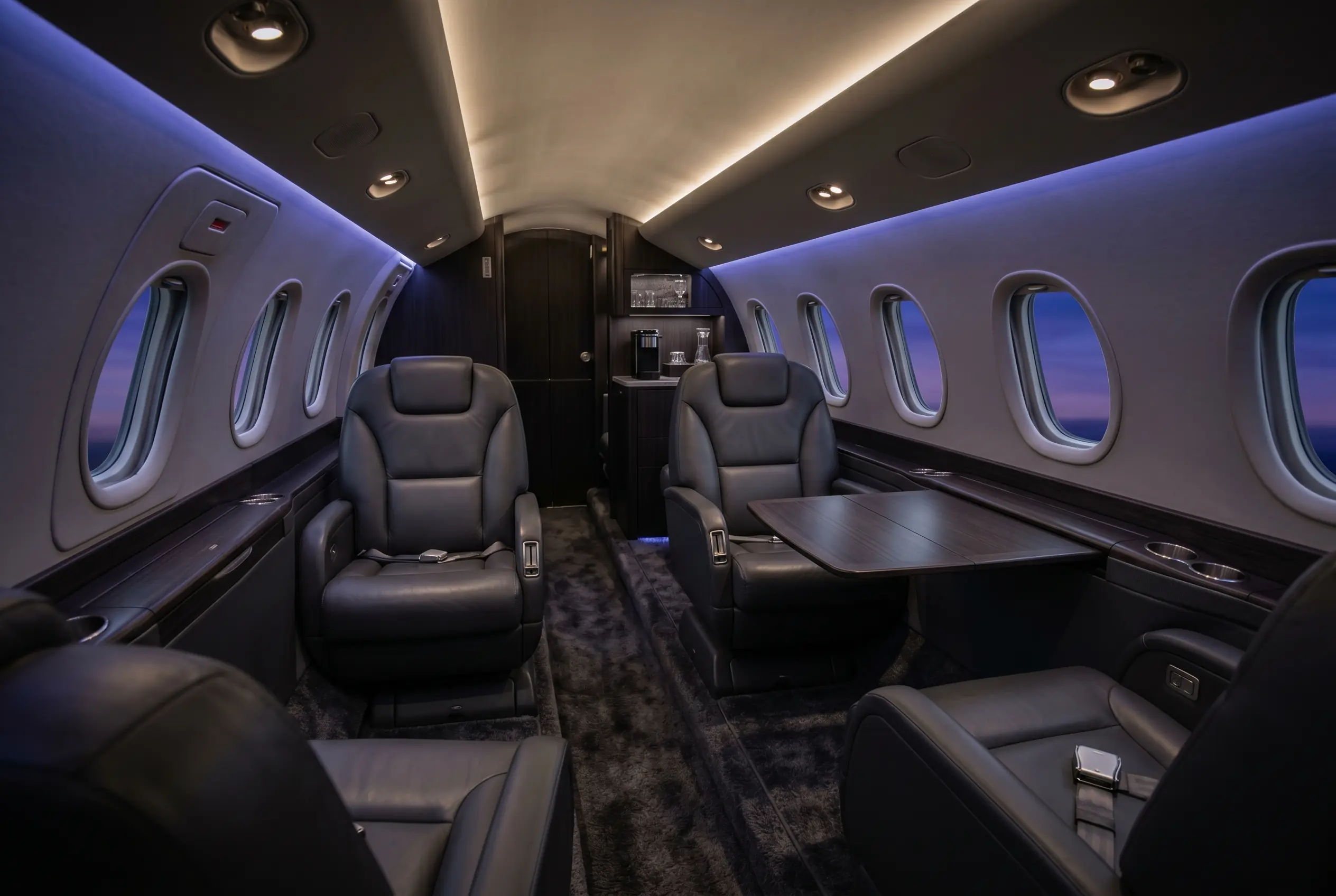 Cessna Citation Excel stand-up cabin with club seating and a refreshment center, configured for a New York to Miami charter