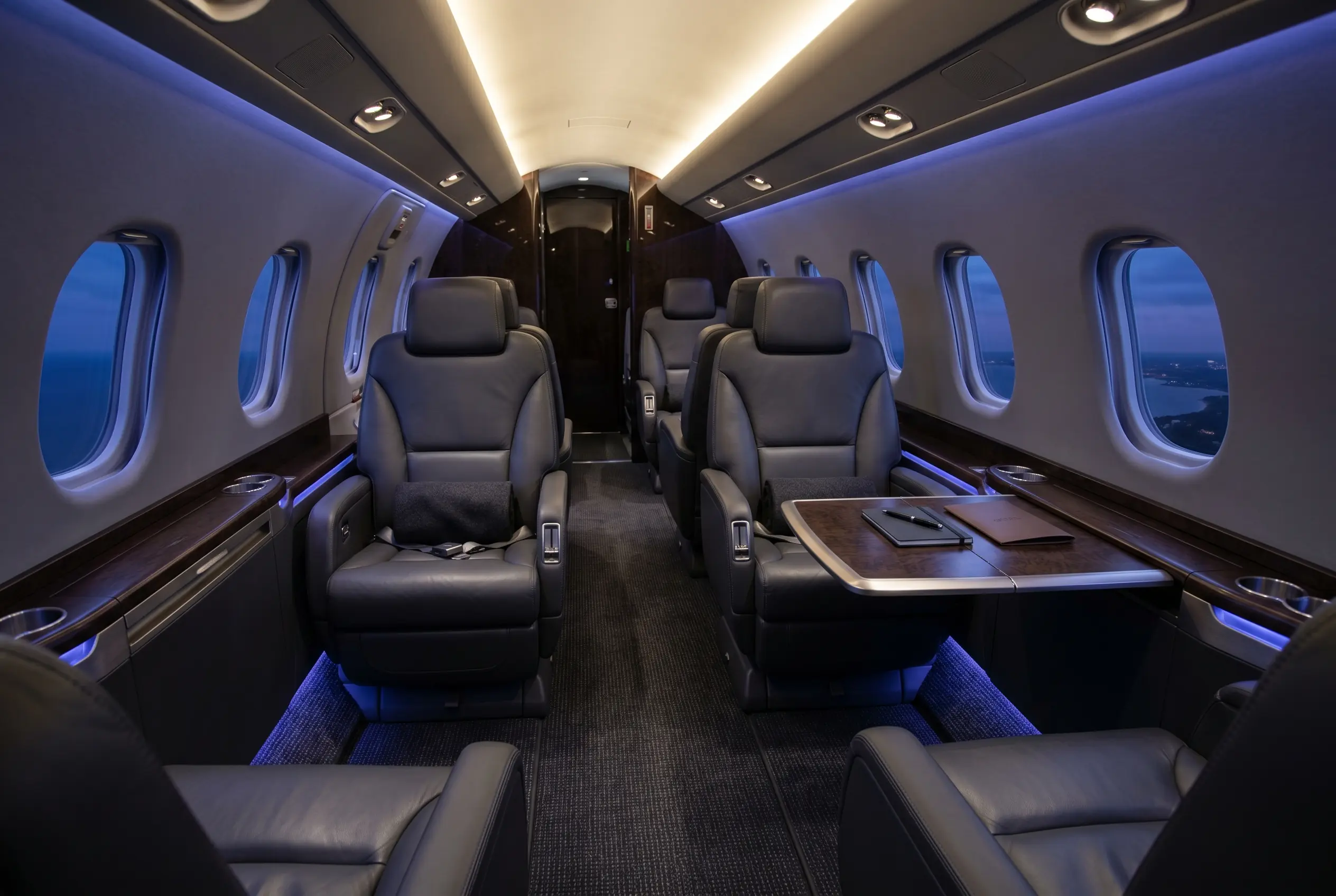Cessna Citation Latitude flat-floor cabin with six-foot standing height and club seating, configured for a New York to Miami charter