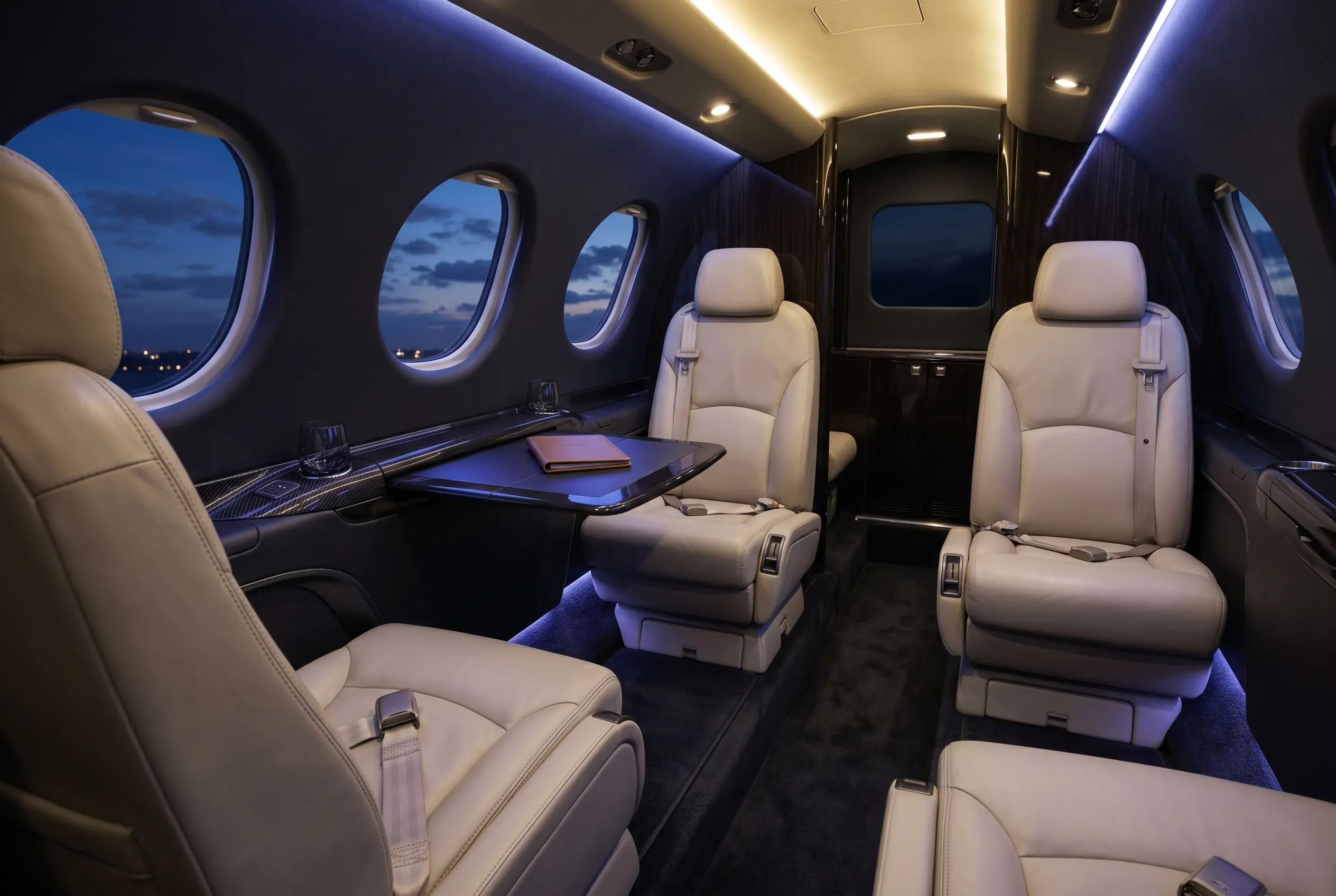 Cessna Citation Mustang cabin with four club seats in light leather, configured for a New York to Miami charter