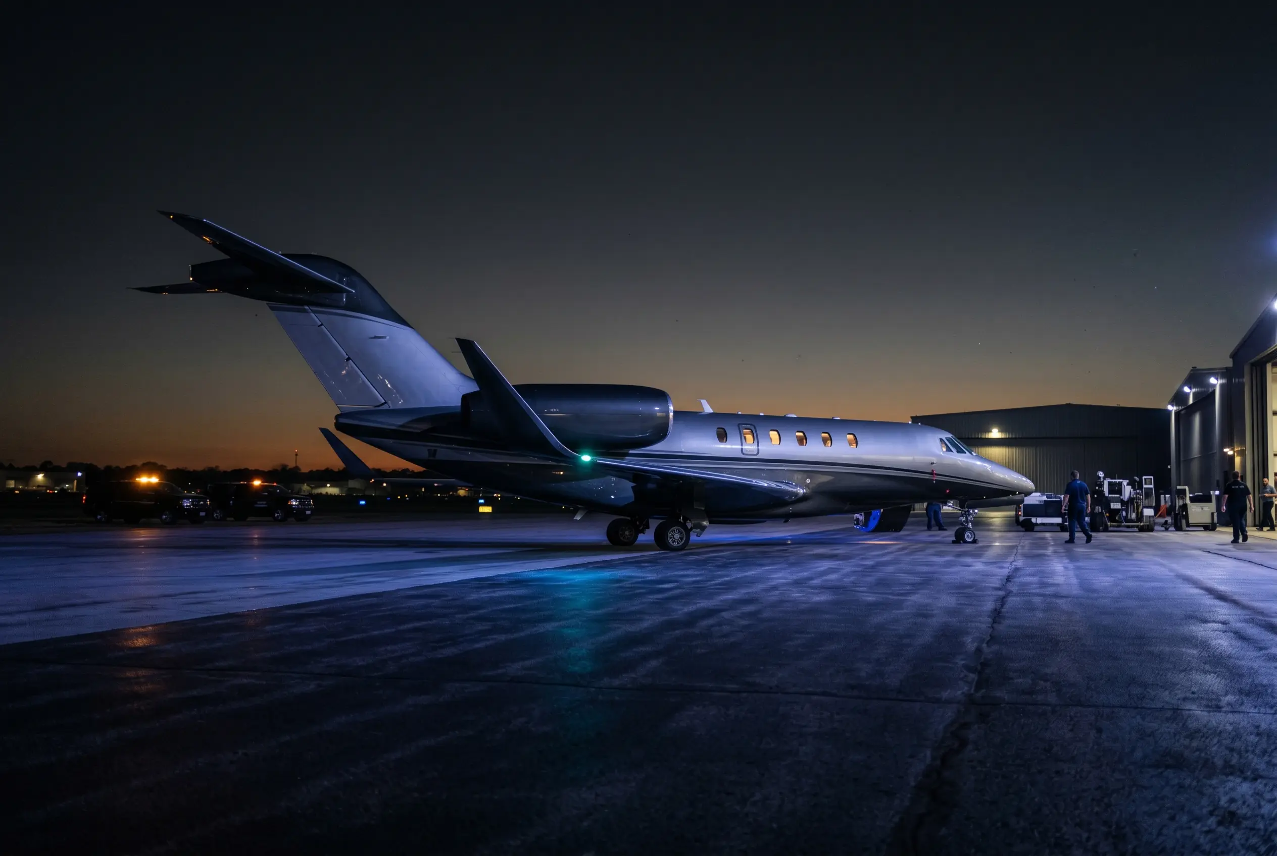 Cessna Citation X with its swept wing on a private ramp at dusk before a New York to Miami departure