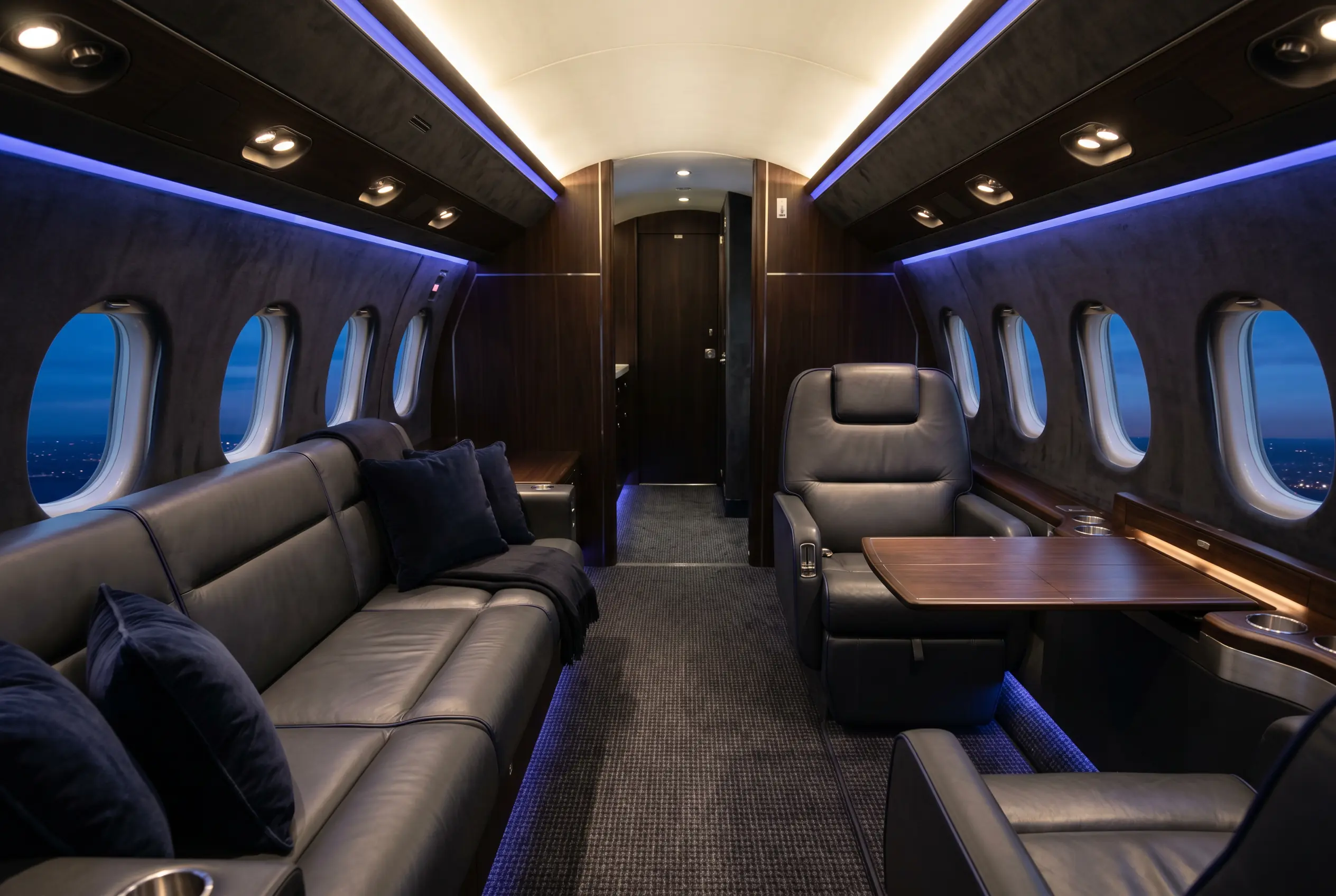 Dassault Falcon 2000LXS wide cabin with facing club seats and a divan, configured for a New York to Miami charter