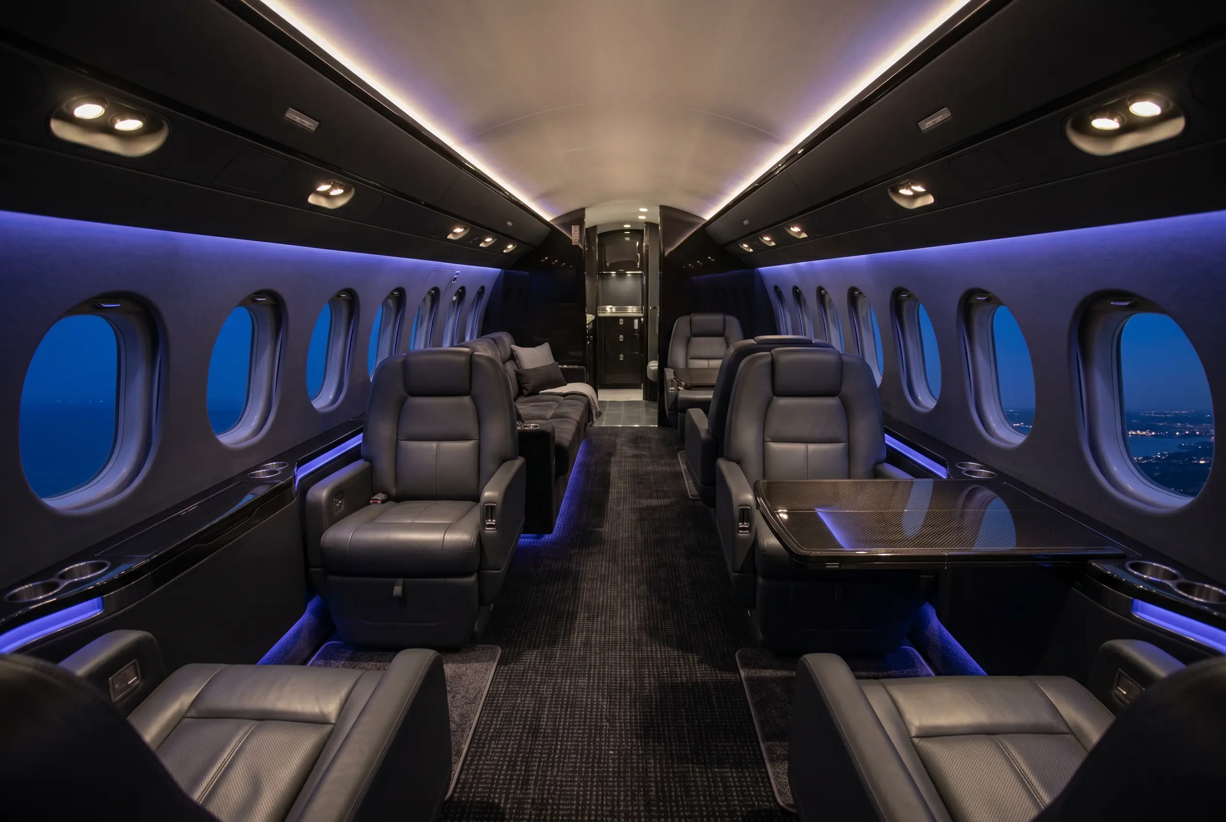 Dassault Falcon 7X large cabin in three living zones with club and divan seating, configured for a New York to Miami charter