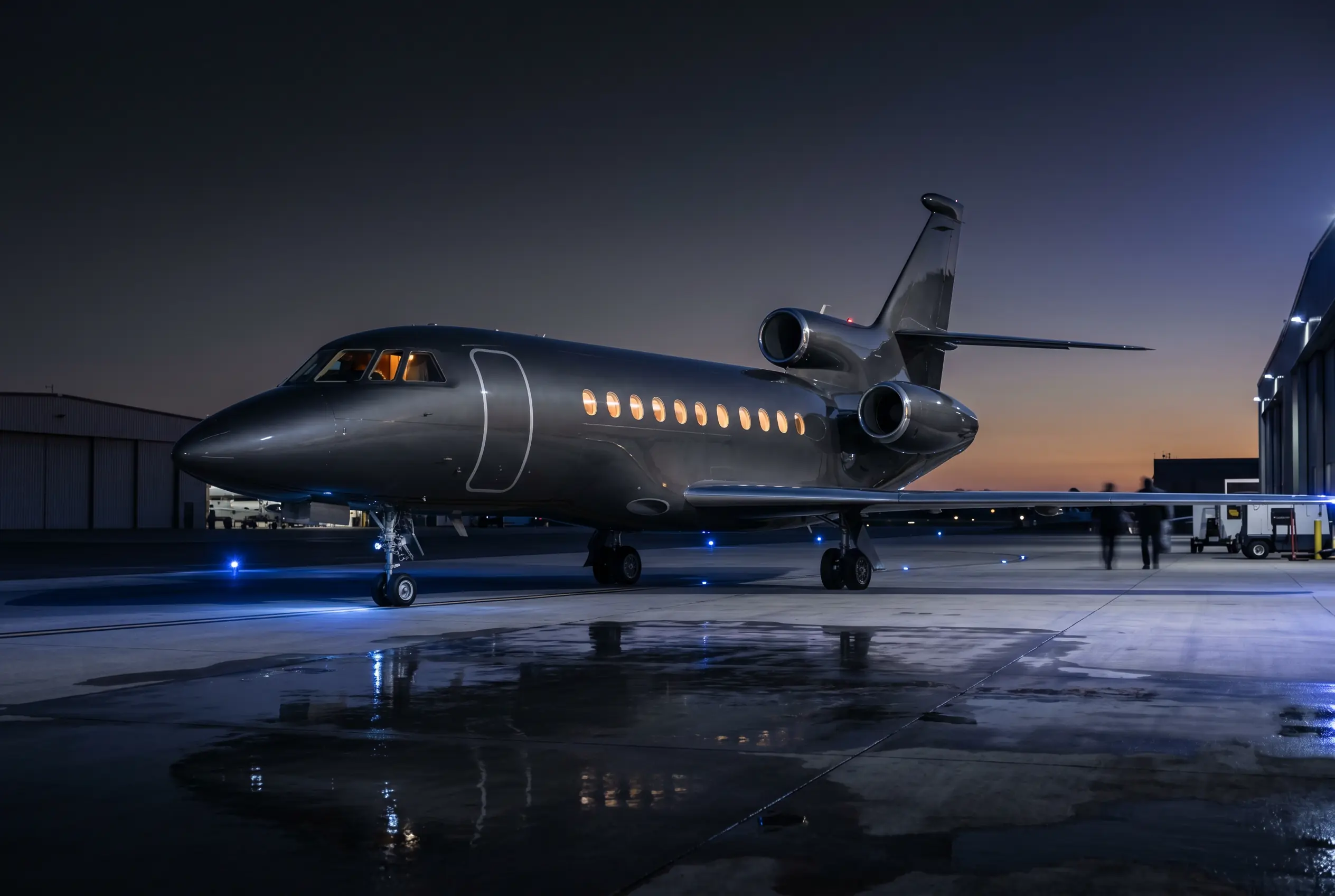 Dassault Falcon 900LX trijet showing its three rear engines on a private ramp at dusk before a New York to Miami departure