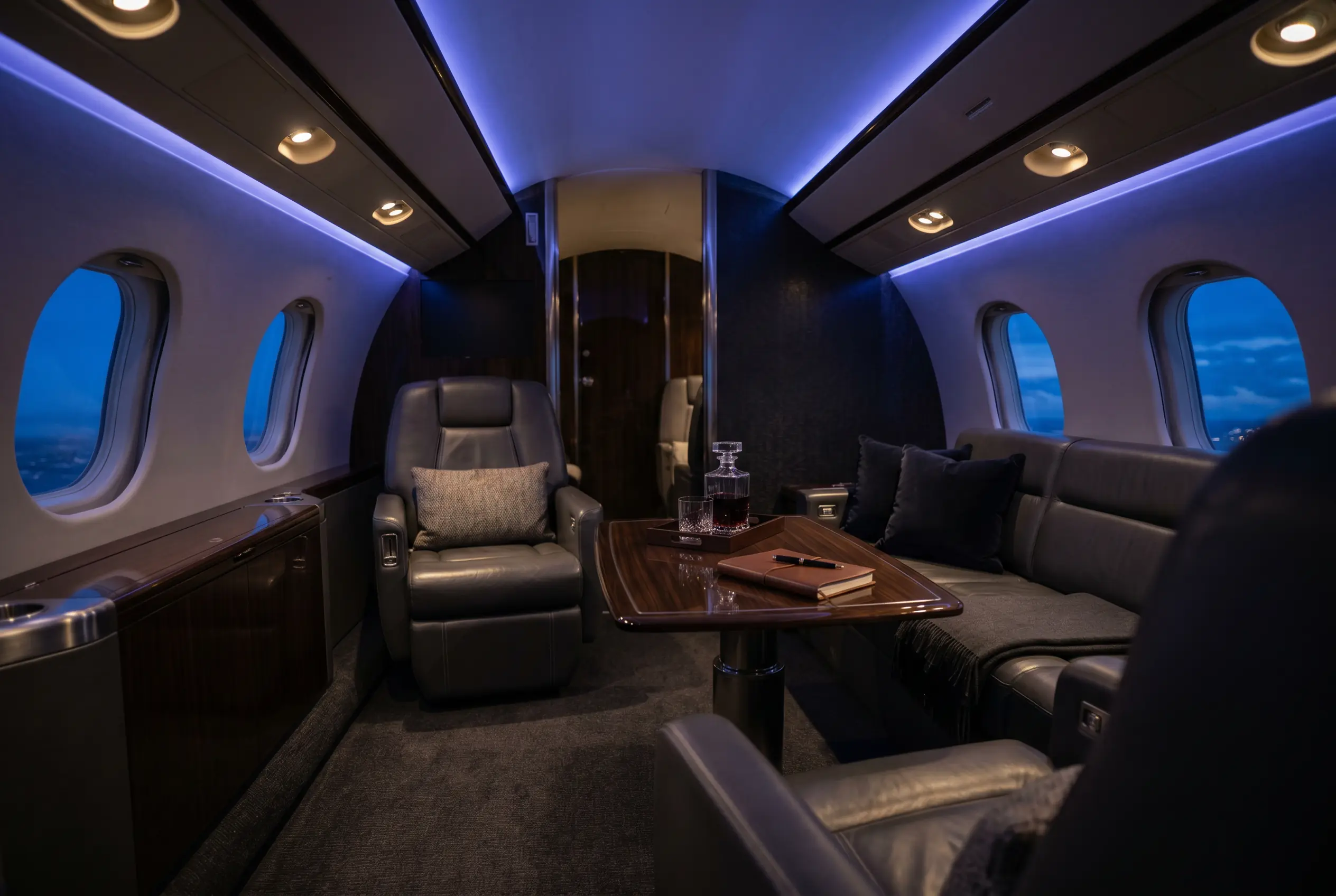 Aft lounge zone of a Bombardier Global 5000 arranged for relaxing during a New York to Miami flight