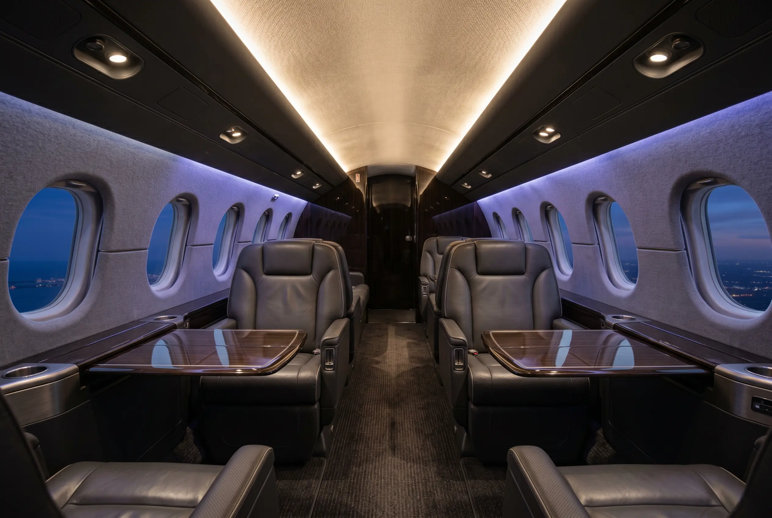 Hawker 4000 wide stand-up cabin with double-club seating, configured for a New York to Miami charter