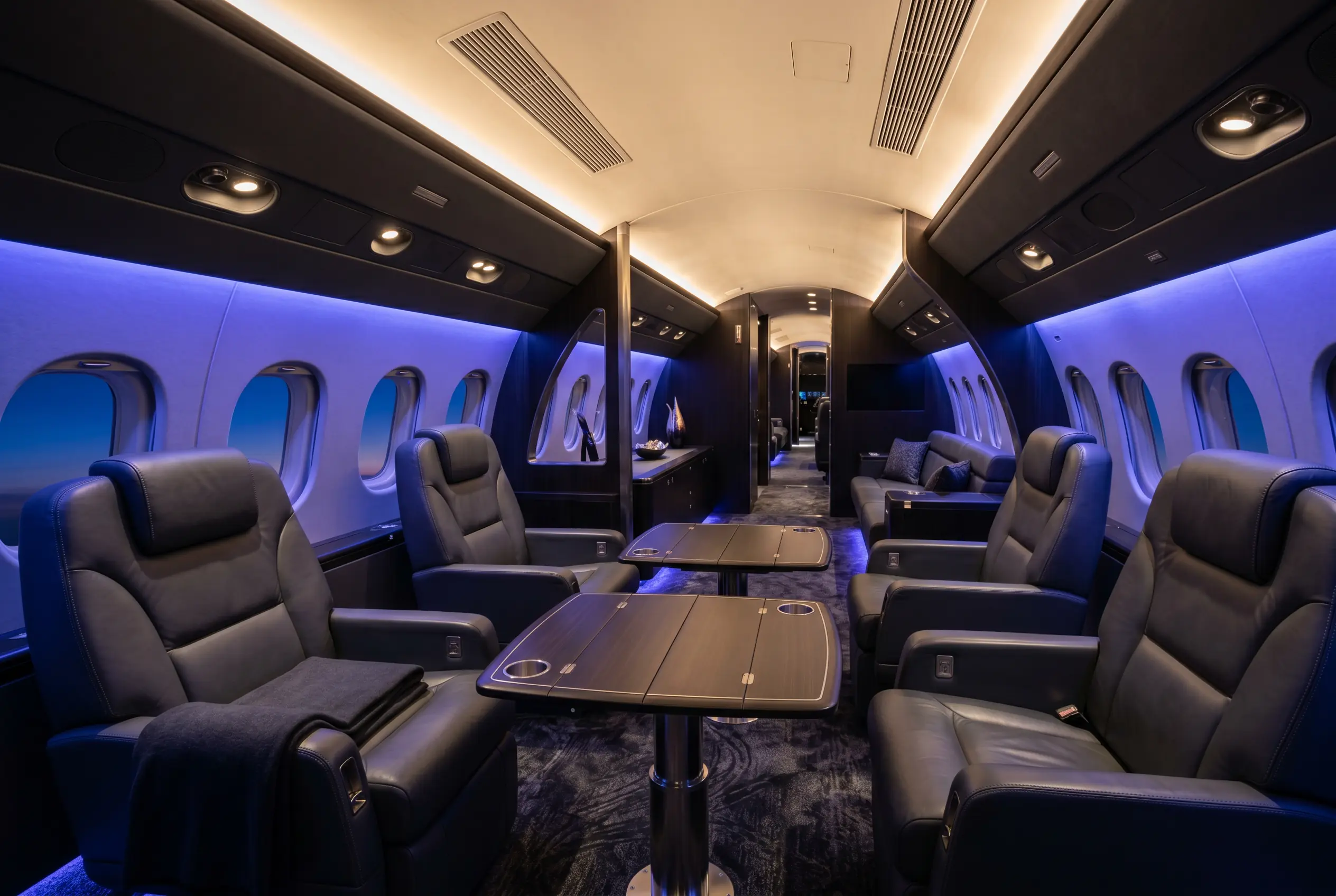 Large heavy jet cabin with multiple living zones and club seating for a New York to Miami charter