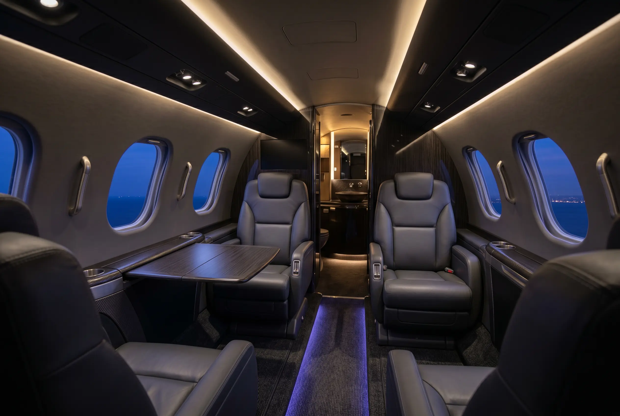 HondaJet Elite II cabin with club seating and a private aft lavatory, configured for a New York to Miami charter