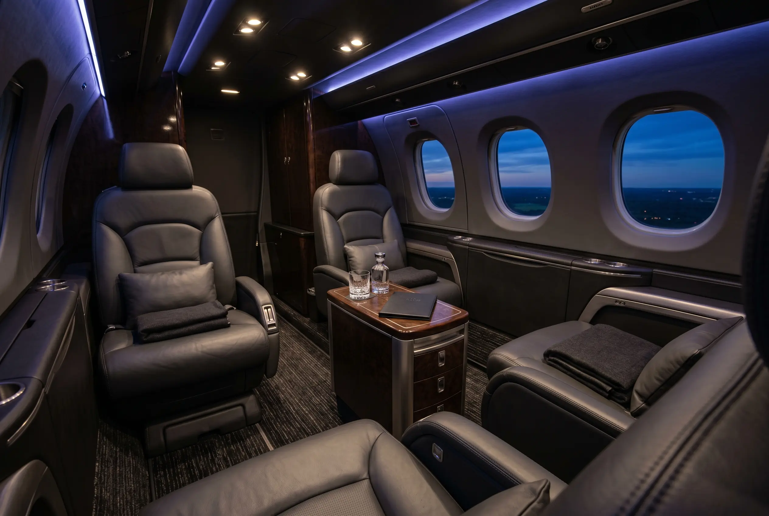 Beechcraft King Air 260 cabin with club-four leather seating and a refreshment console, configured for a New York to Miami charter