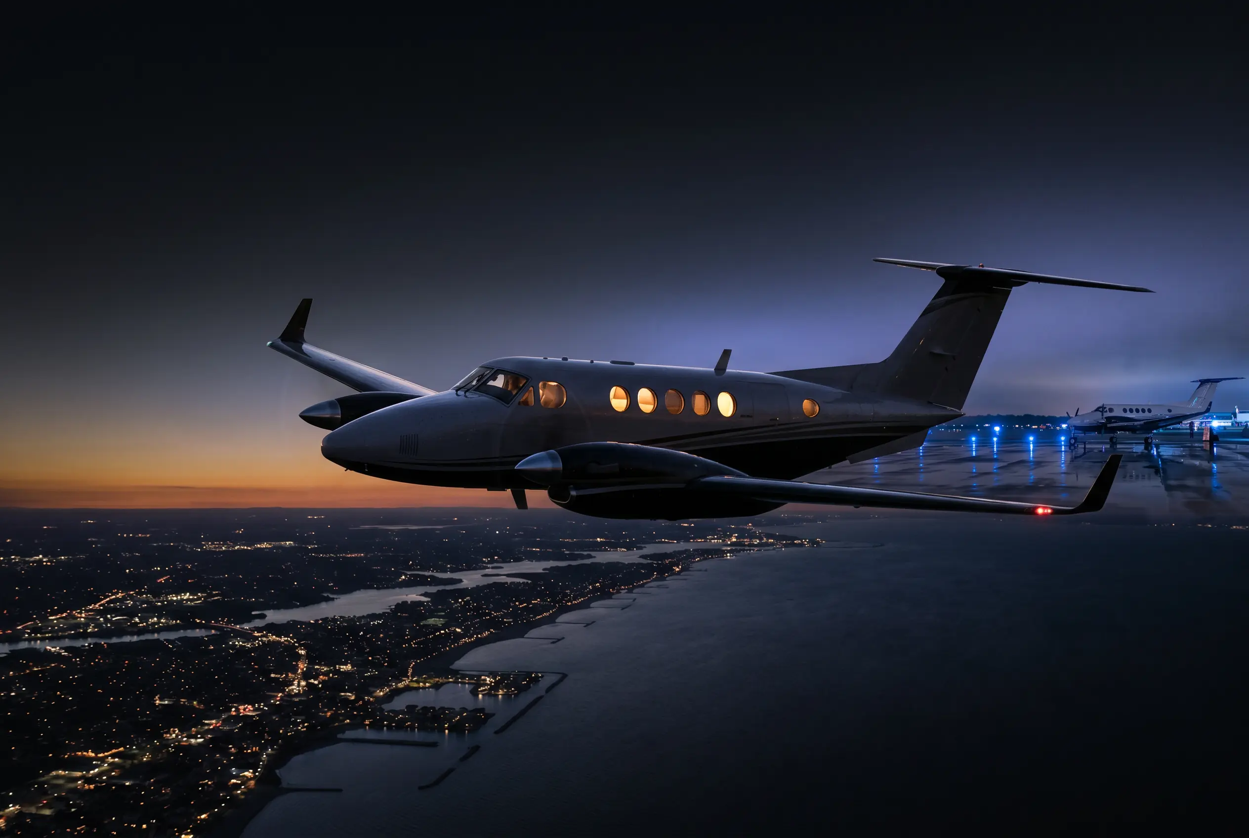 Beechcraft King Air 260 in flight above the Eastern Seaboard at dusk en route from New York to Miami