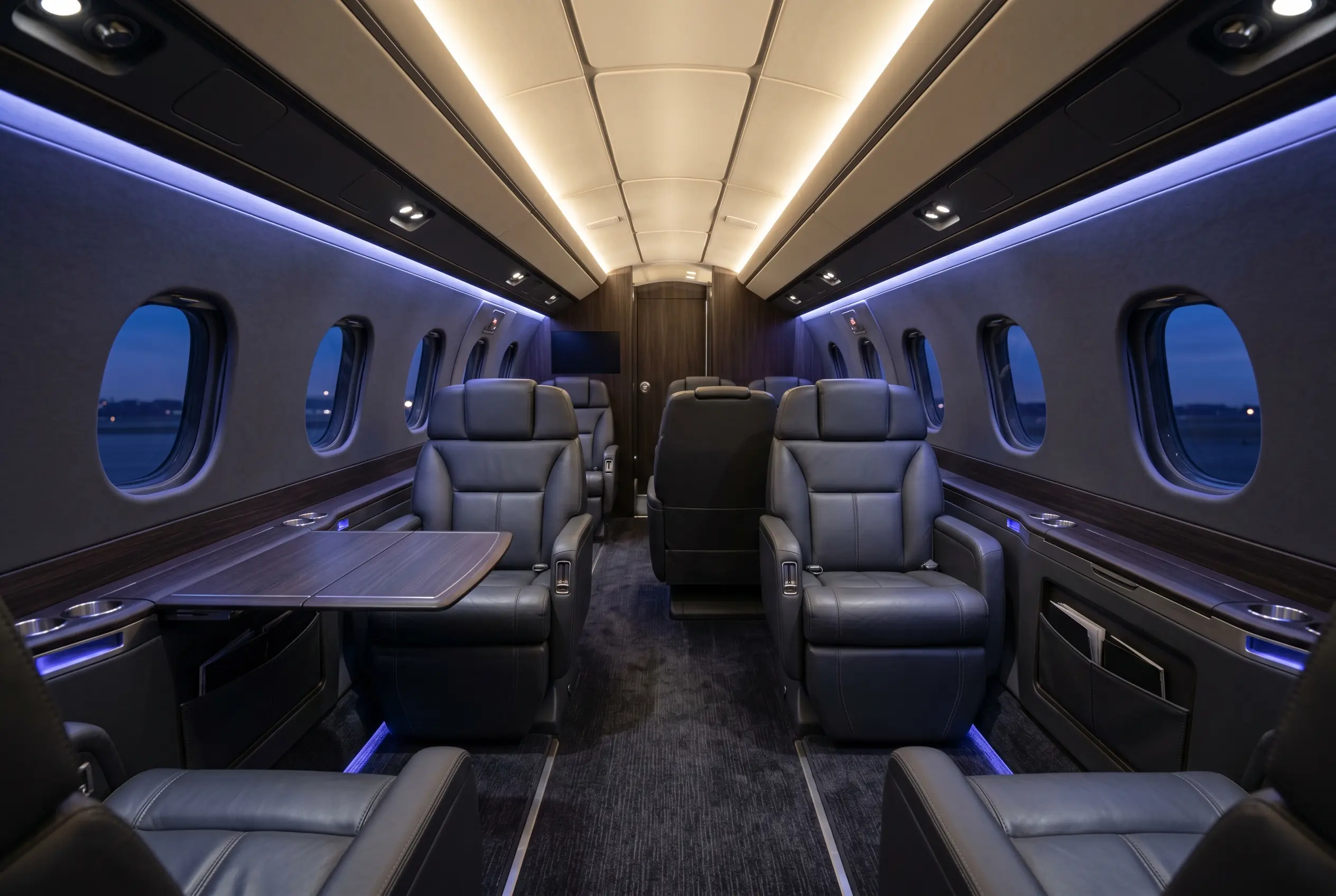 Embraer Legacy 500 flat-floor cabin with six-foot standing height and double-club seating, configured for a New York to Miami charter