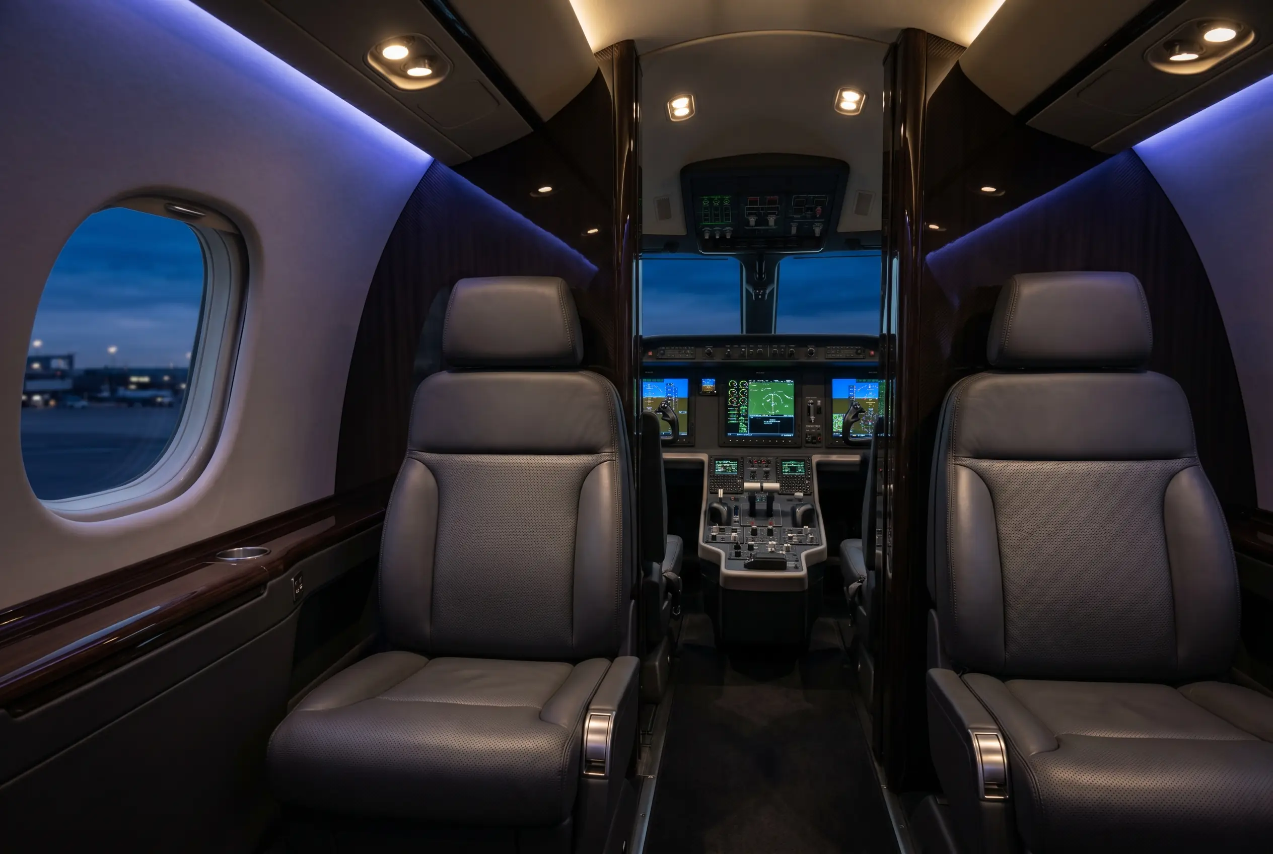 Embraer Legacy 500 fly-by-wire glass cockpit illuminated at dusk ahead of a New York to Miami flight