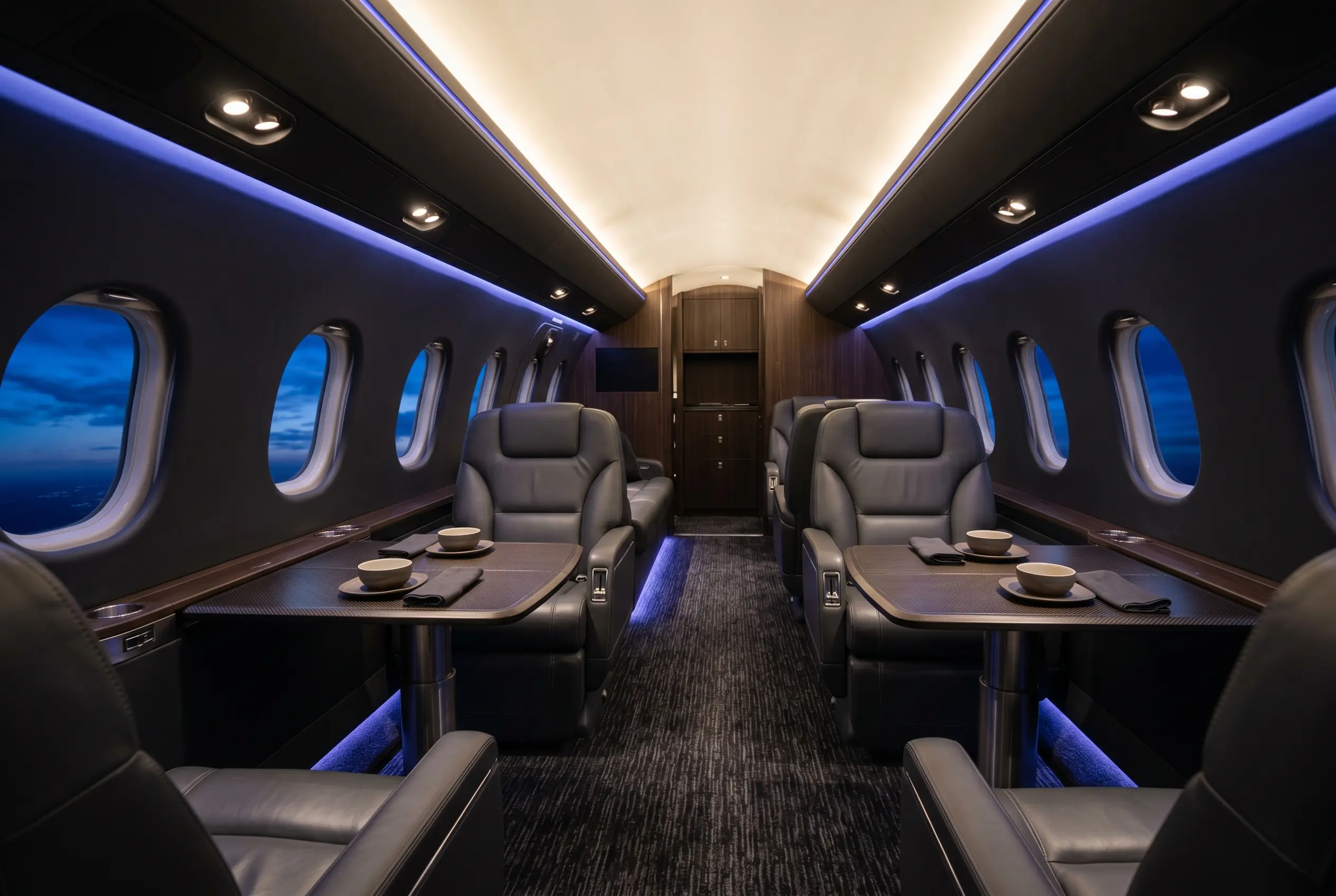 Midsize jet cabin with full stand-up height and club seating for a New York to Miami charter