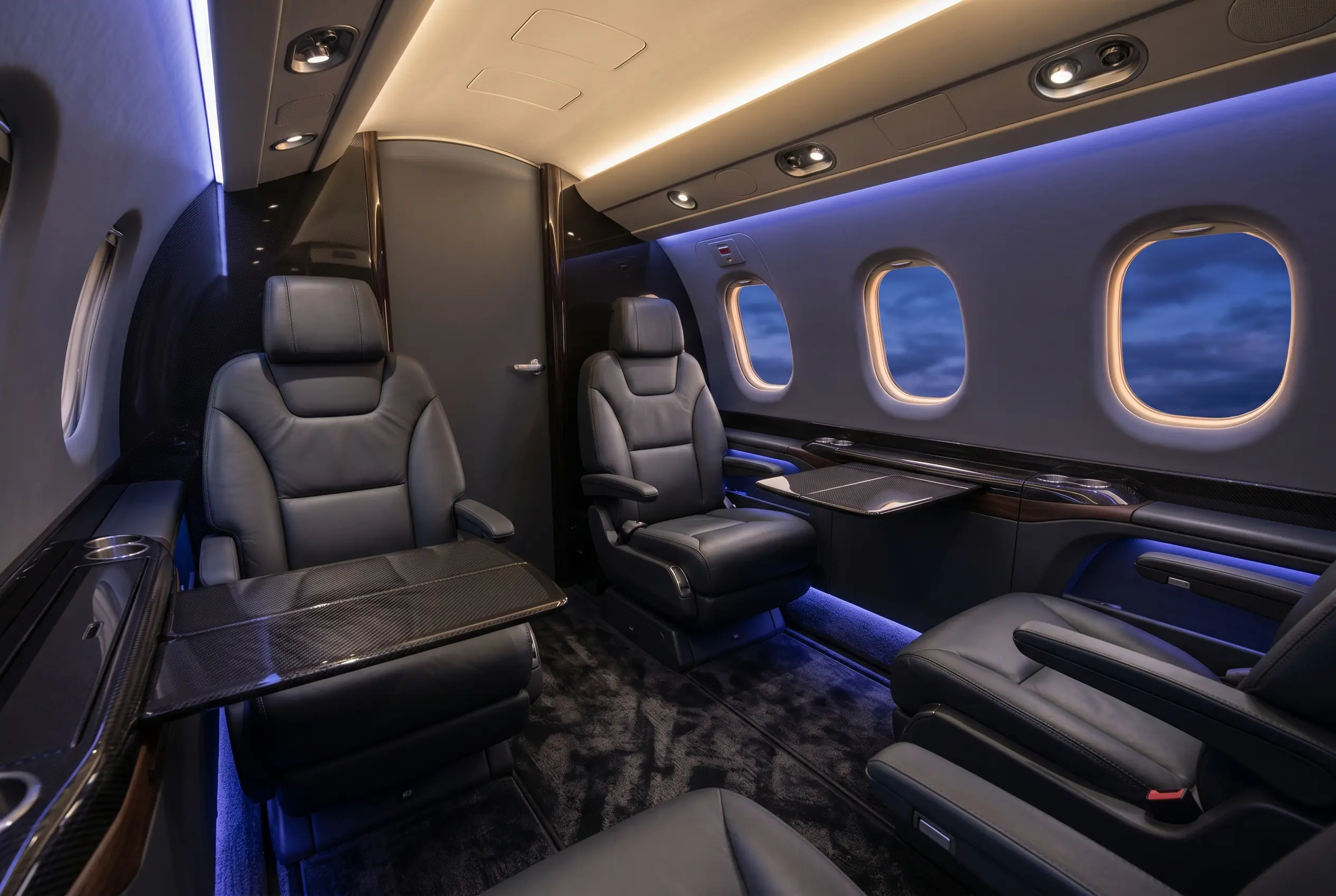 Pilatus PC-24 flat-floor cabin with club seating and an executive layout, configured for a New York to Miami charter