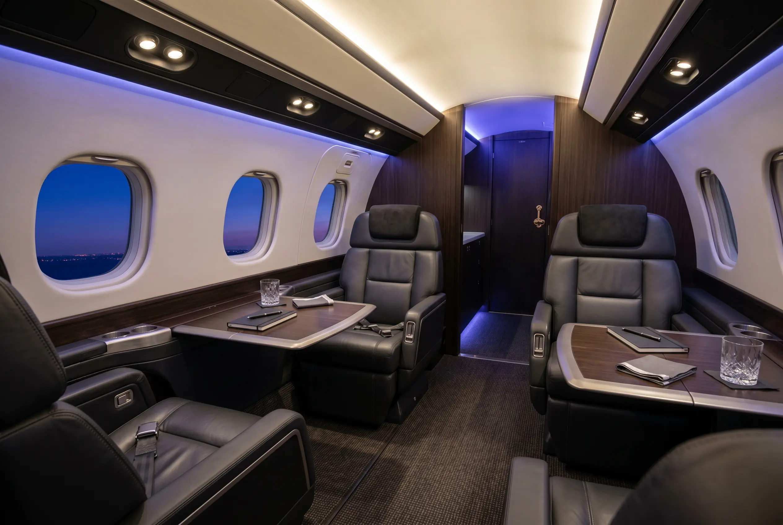 Embraer Praetor 600 flat-floor cabin with six-foot headroom and club seating, configured for a New York to Miami charter