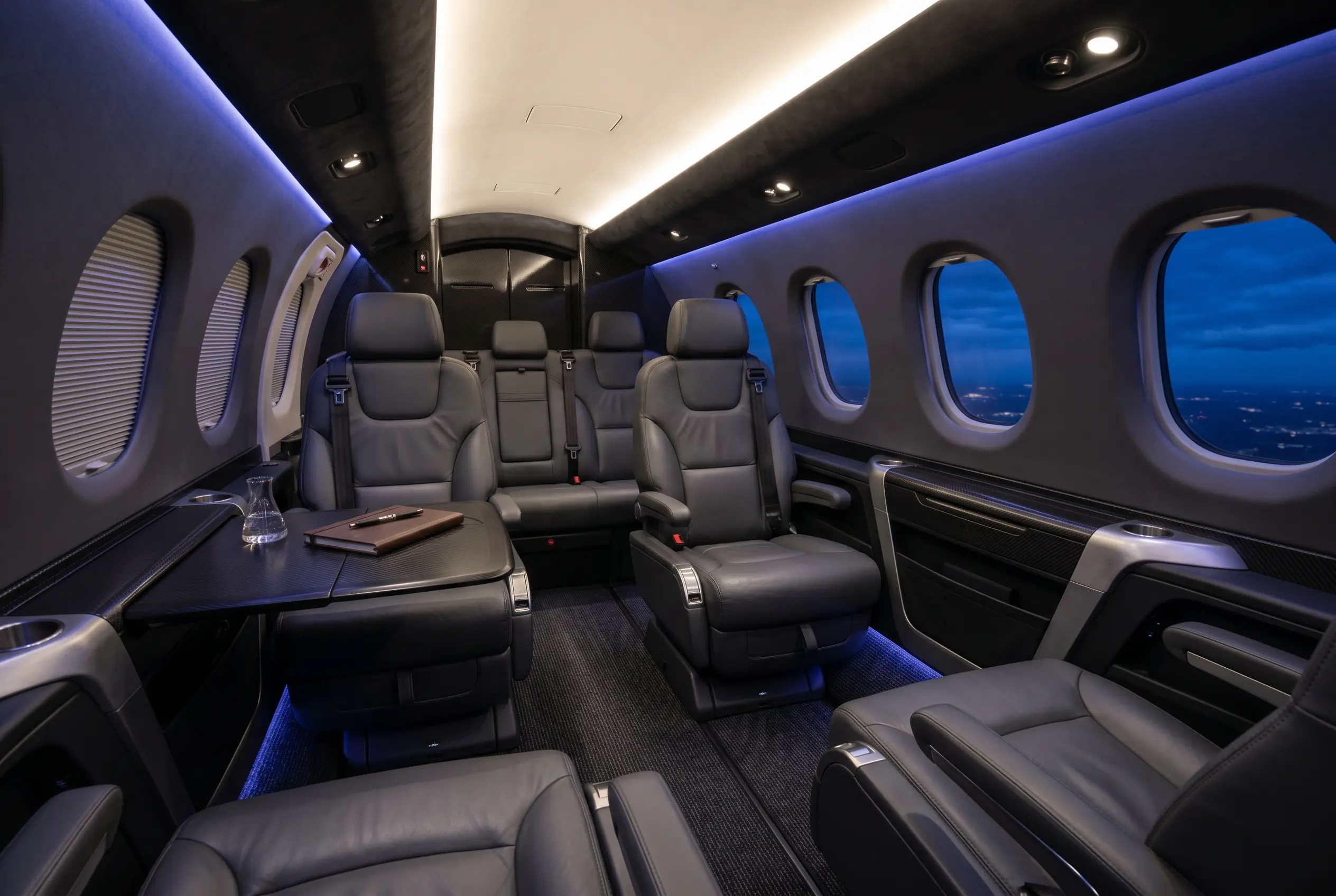 Daher TBM 960 four-seat cabin with leather club seating and large windows, configured for a New York to Miami charter